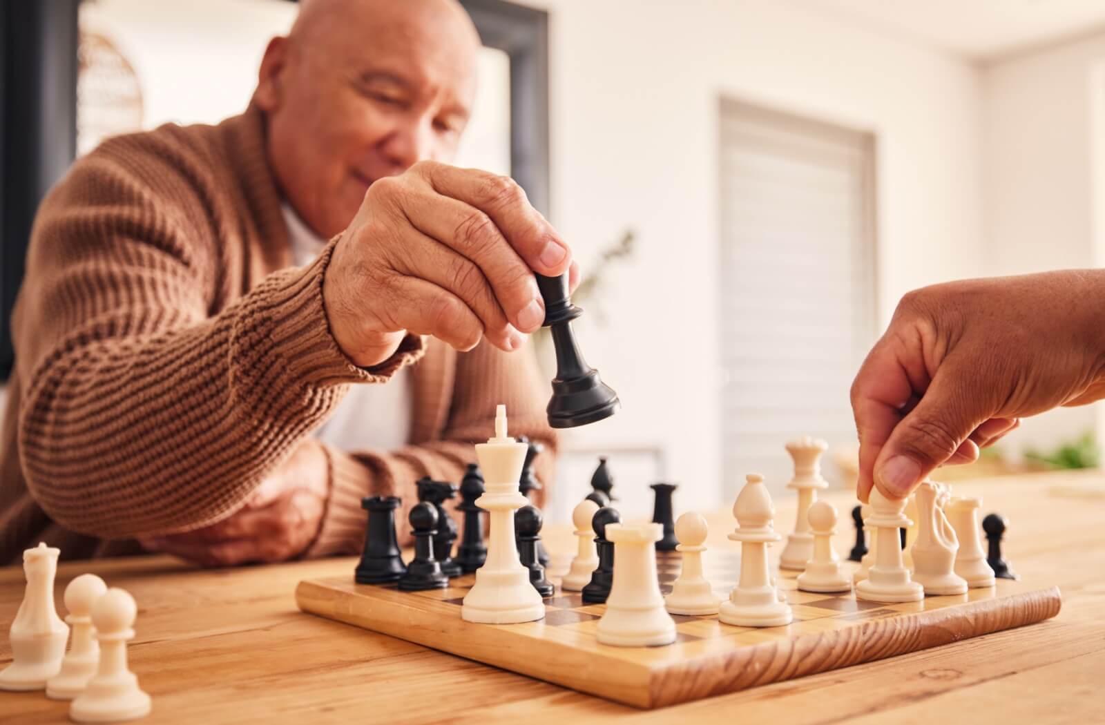 A couple of seniors play a game of chess, keeping their minds active.